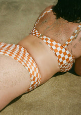 women_on_beach_wearing_milly_checker_bikini_top