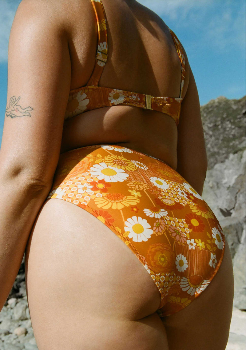 close_up_of_woman_wearing_floral_polly_high_waist_bikini_bottoms